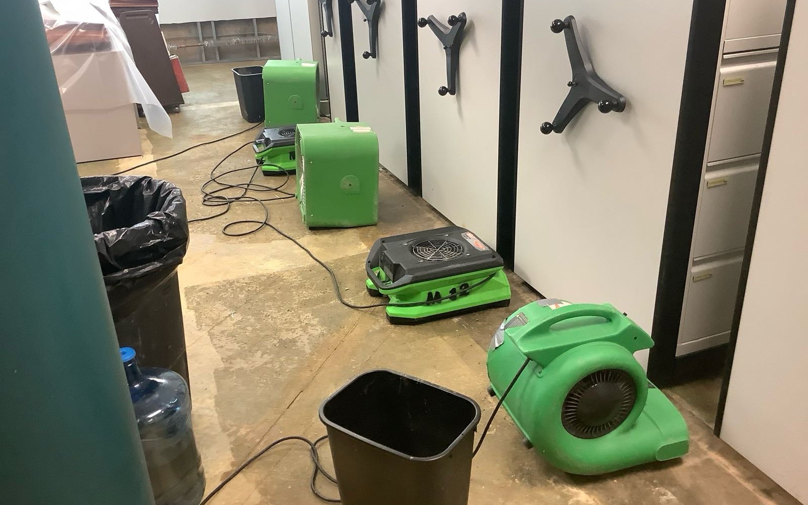 Air movers and dehumidification equipment staged after water damage