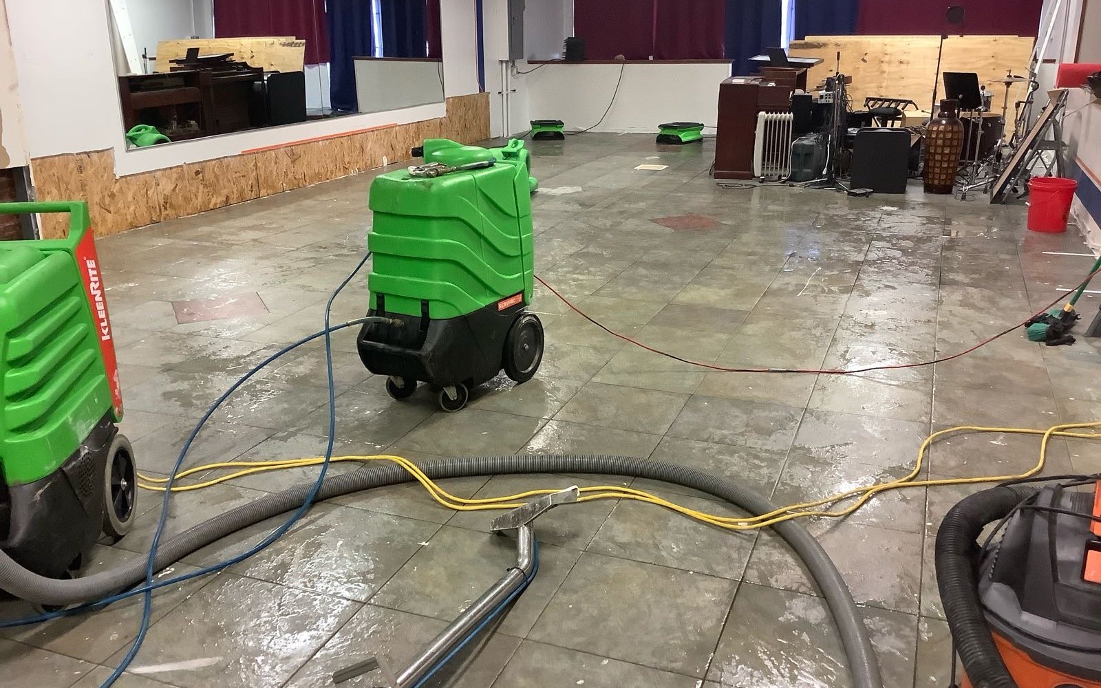 Commercial restoration equipment drying a wet tile floor