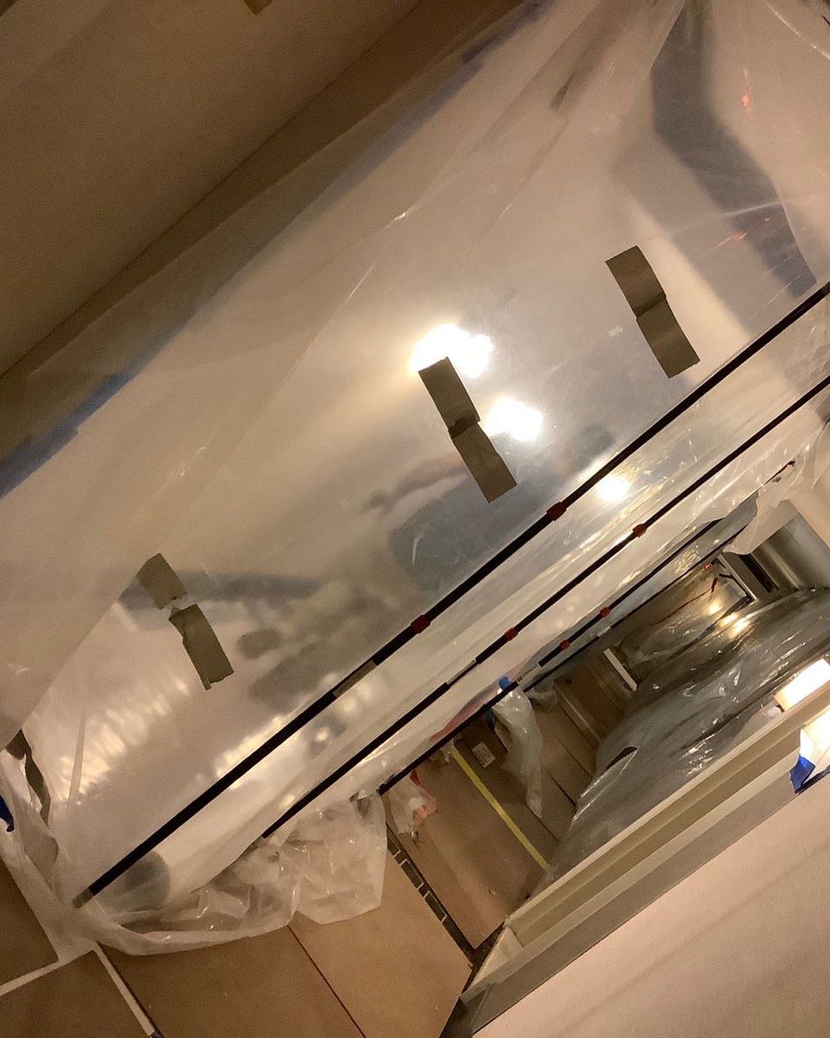 Ceiling and wall materials opened in a commercial hallway during restoration