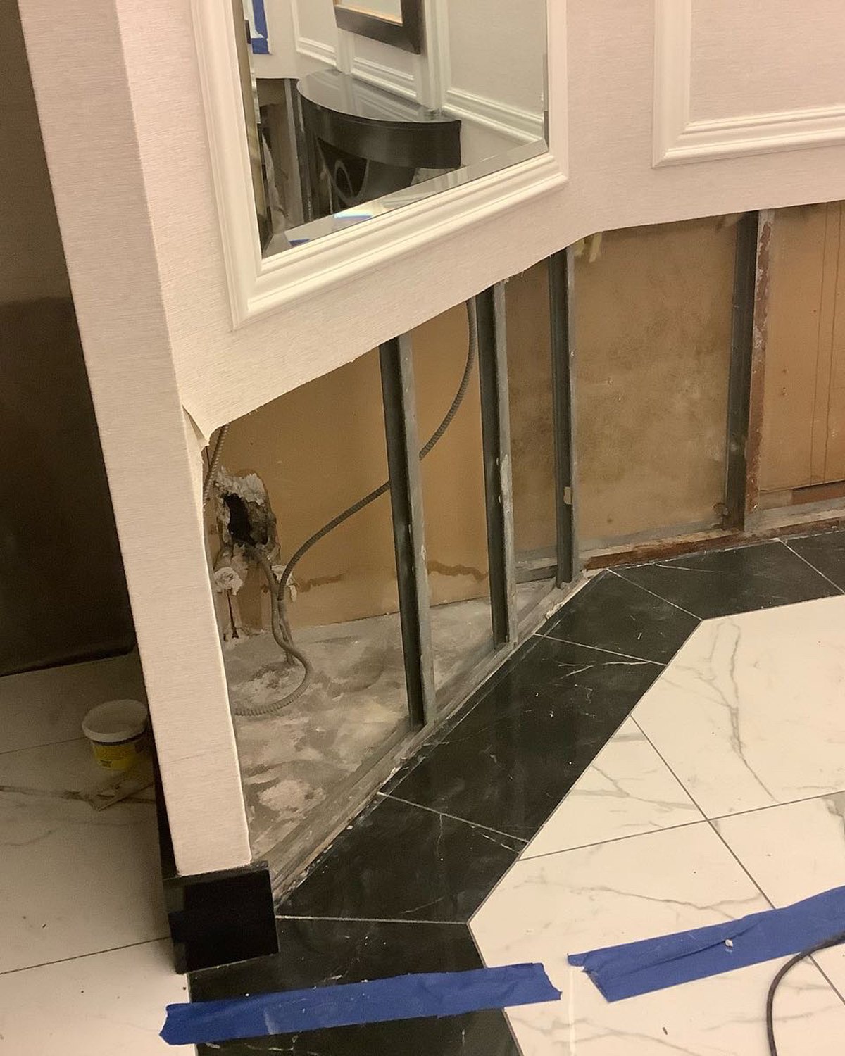 Elevator lobby with lower wall materials removed during restoration