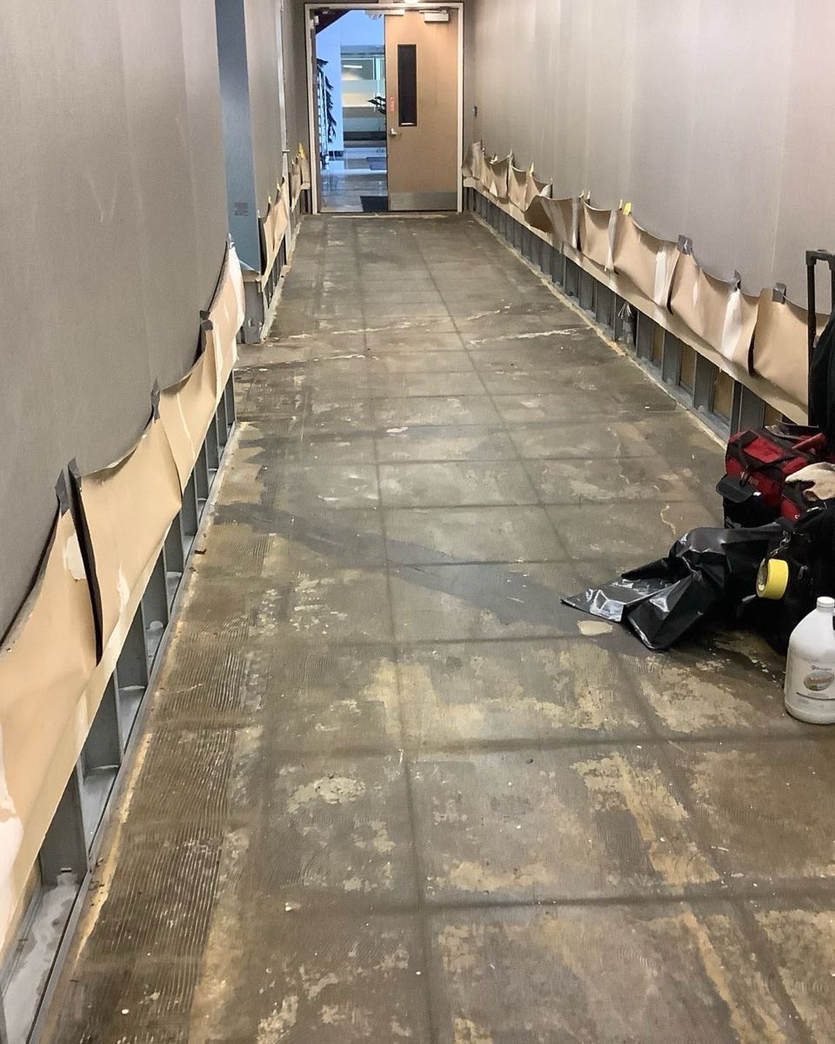 Commercial hallway with lower wall sections removed during remediation