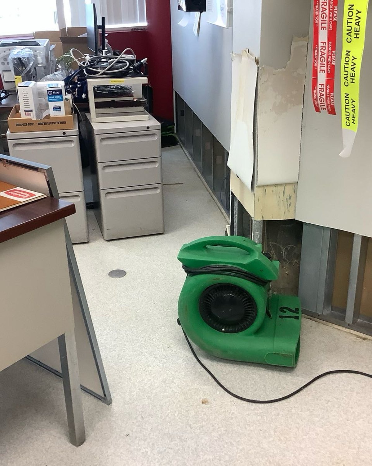 Commercial space staged with air-moving equipment during emergency drying