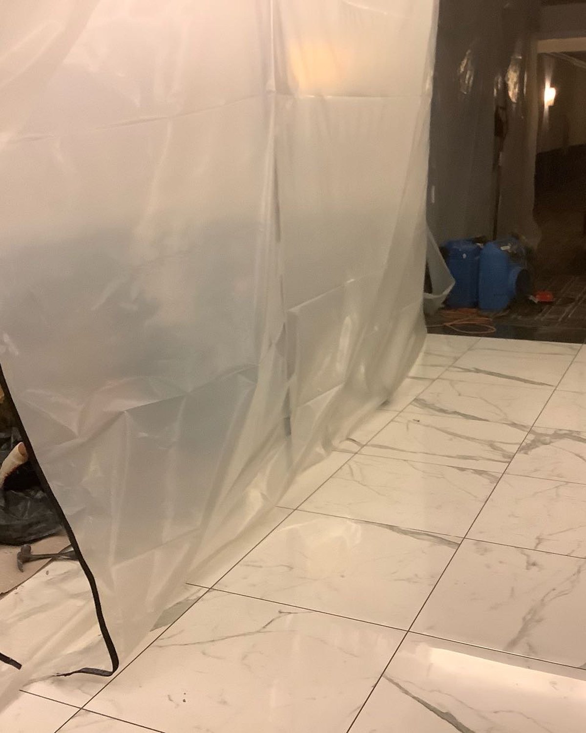 Protected elevator lobby with lower wall finishes removed for restoration