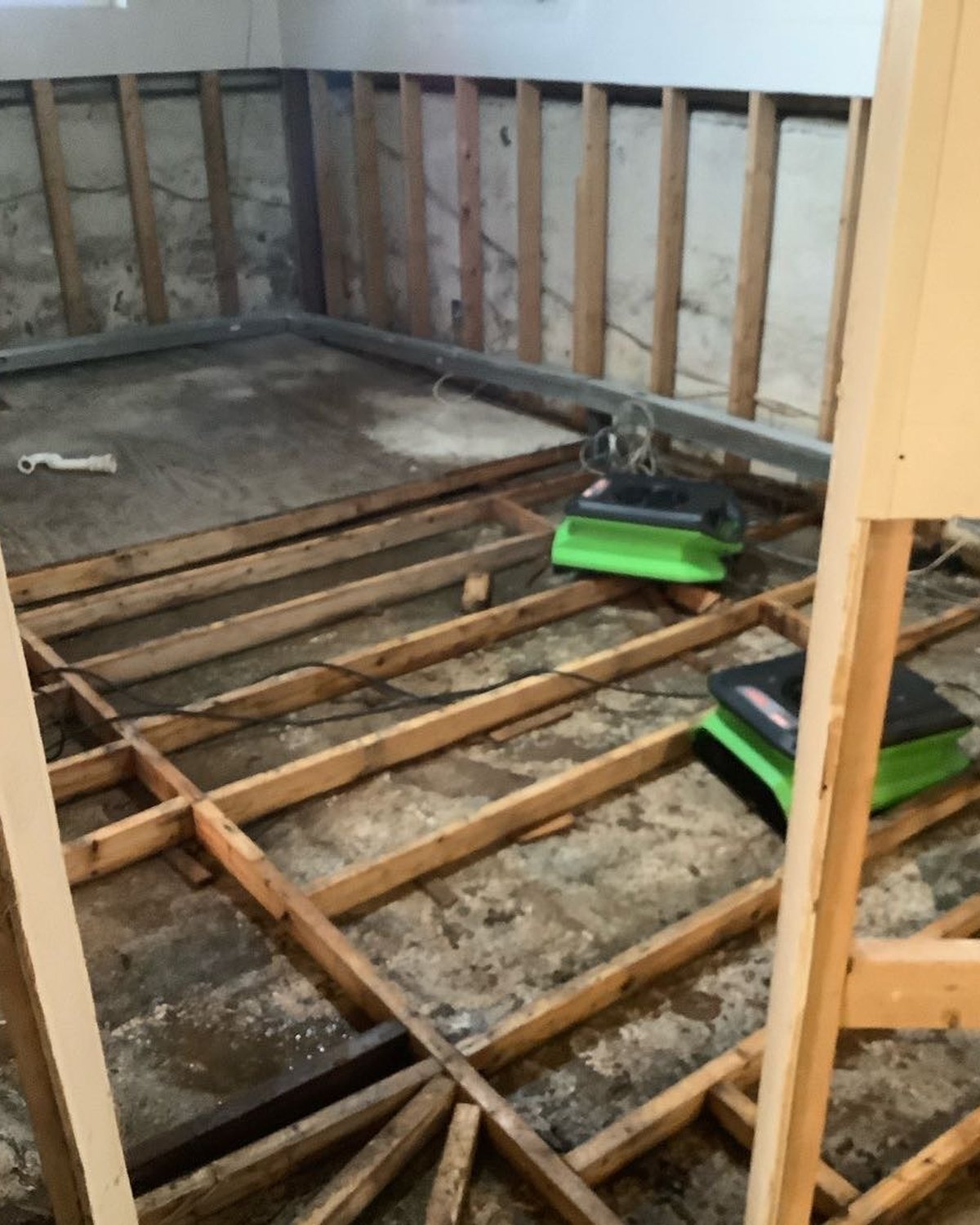 Flooring removed after emergency water damage exposed the framing below