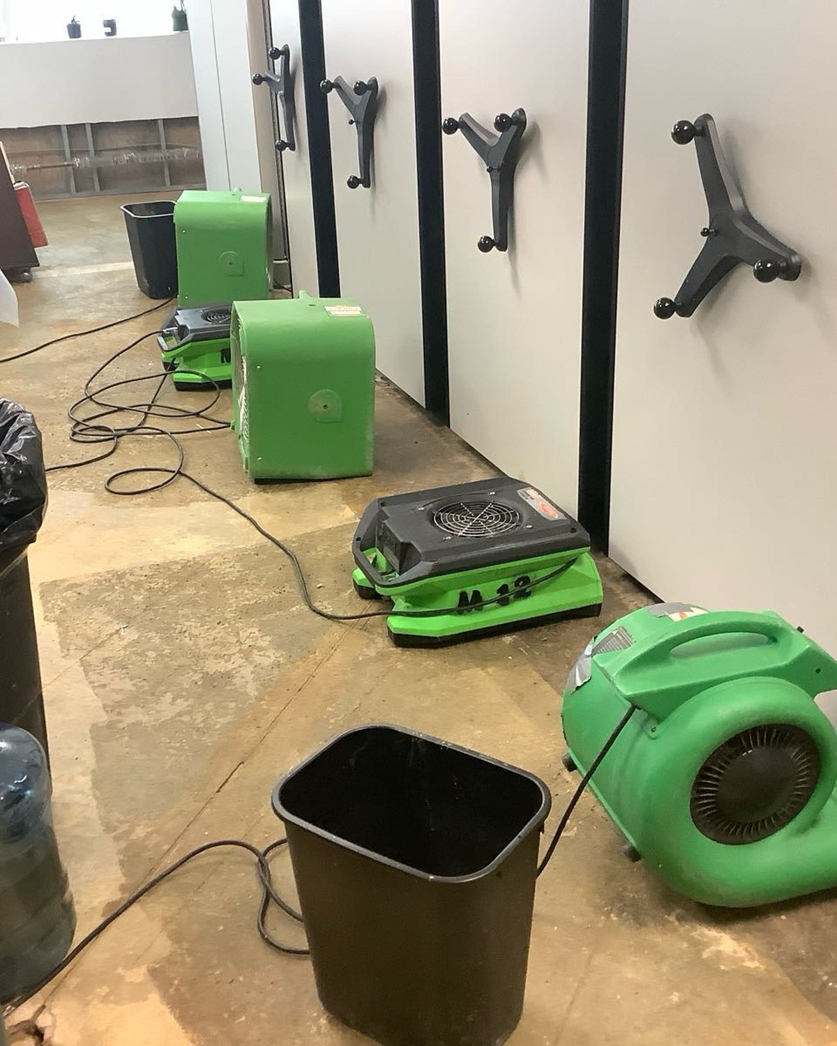 Commercial restoration equipment staged inside a water-damaged space